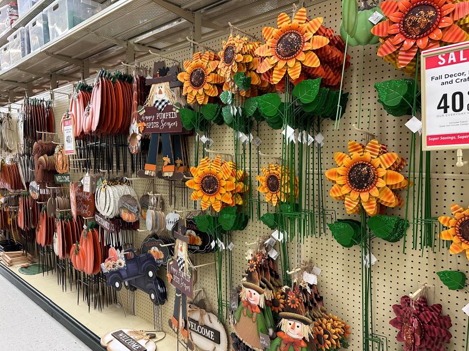 Sunflower-shaped wheels and scarecrow signs in Hobby Lobby aisle