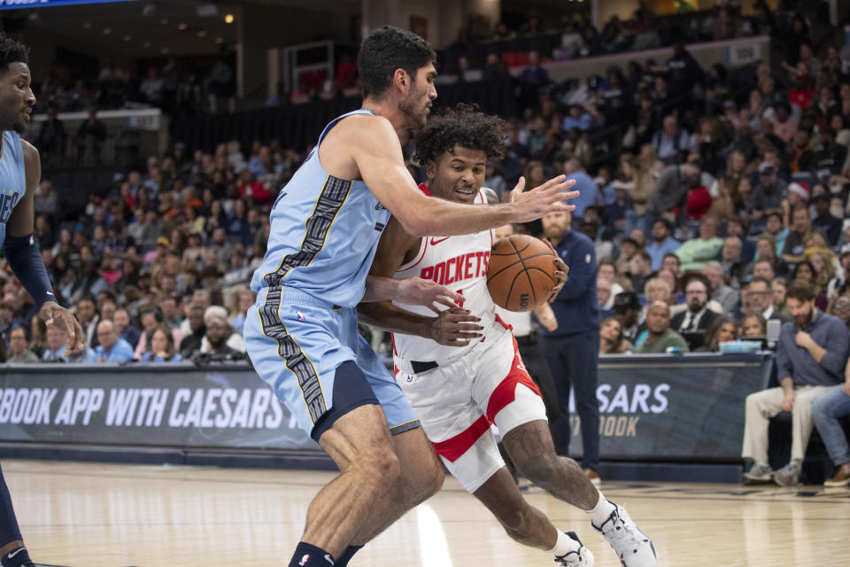 Memphis Grizzlies forward Santi Aldama (7) defends against Houston Rockets guard Jalen Green (4) during the first half of an NBA basketball game Friday, Dec. 15, 2023, in Memphis, Tenn. (AP Photo/Nikki Boertman)