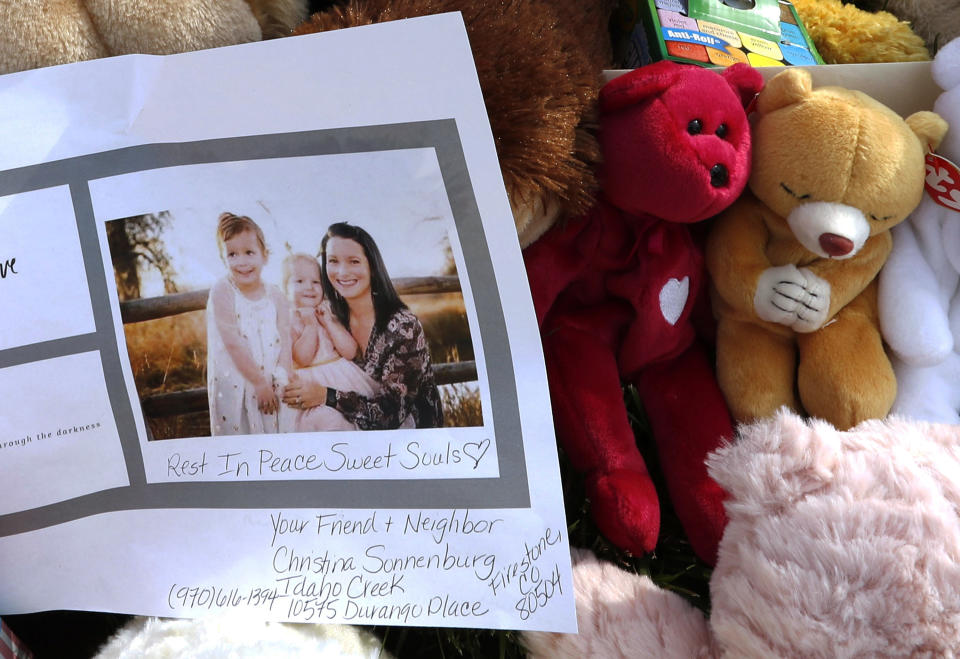 FILE - In this Aug. 16, 2018, file photo, a photograph of Shanann Watts and her daughters, Bella, 4, left, and Celeste, 3, is shown at a makeshift memorial in Frederick, Colo. Charges were filed Monday, Aug. 20, 2018, against 33-year-old Christopher Watts in the deaths of his pregnant wife and their two young daughters. (AP Photo/David Zalubowski, file)