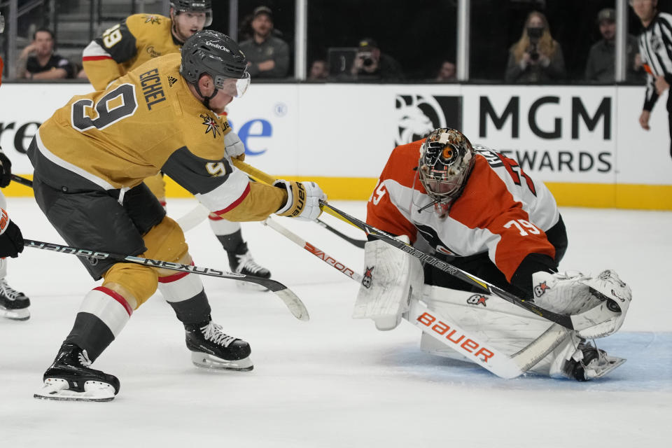 Philadelphia Flyers goaltender Carter Hart (79) blocks a shot by Vegas Golden Knights center Jack Eichel (9) during the second period of an NHL hockey game Tuesday, Oct. 24, 2023, in Las Vegas. (AP Photo/John Locher)