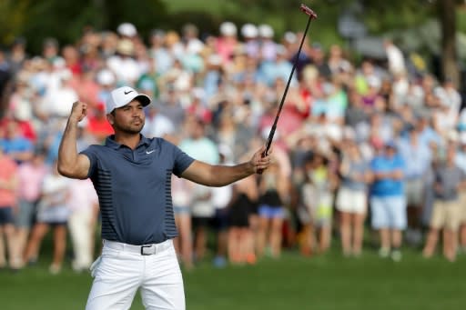 Jason Day of Australia reacts following his par putt on the 18th green