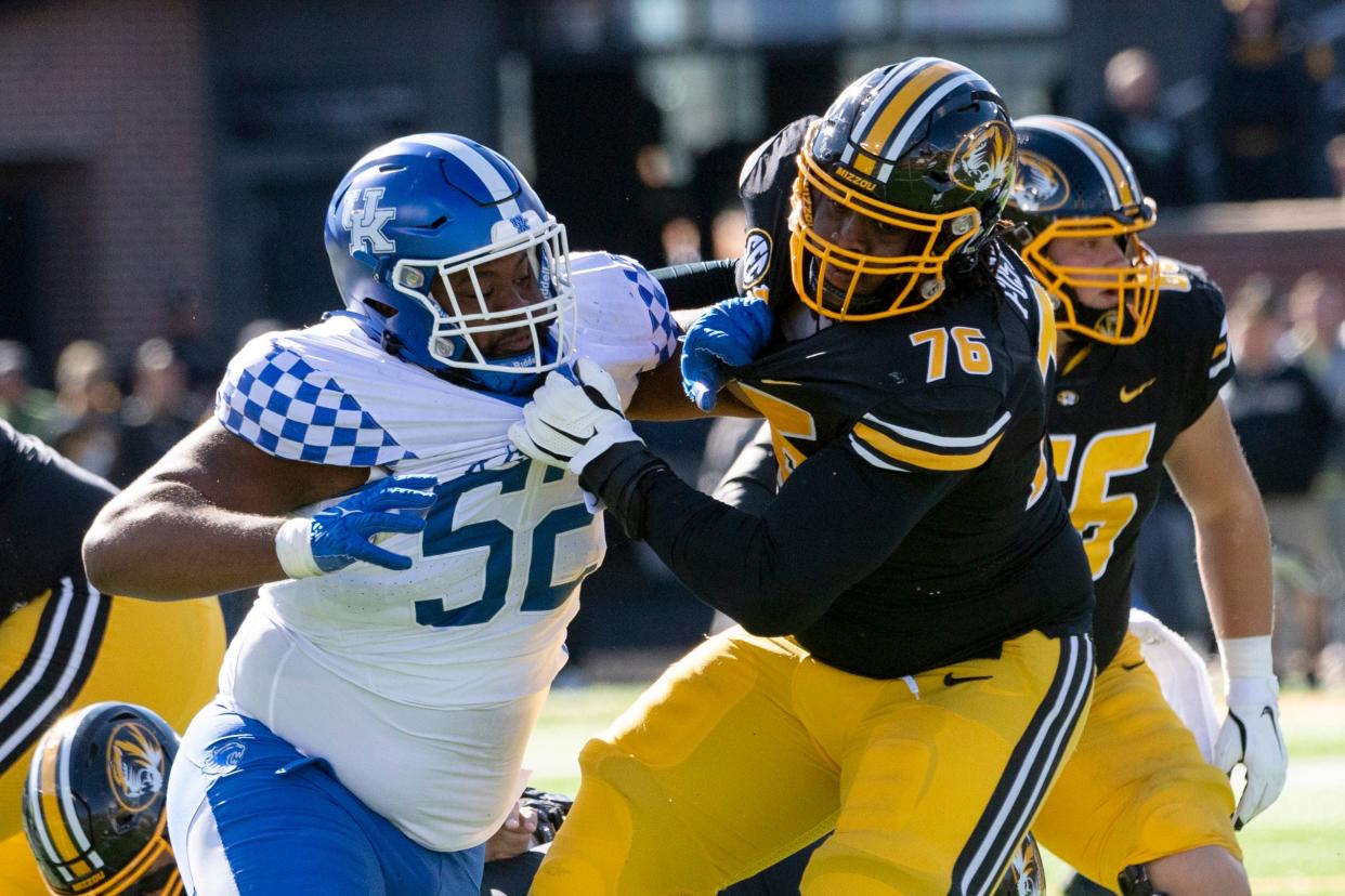 Kentucky defensive lineman Justin Rogers, left, fights his way past Missouri's Javon Foster, right, during the fourth quarter of an NCAA college football game Saturday, Nov. 5, 2022, in Columbia, Mo. (AP Photo/L.G. Patterson)