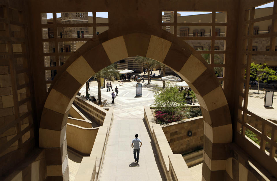 FILE - In this May 9, 2011 file photo, students walk in the campus of the American University in Cairo, in New Cairo, Egypt. In the summer of 2020, more than a hundred allegations of sexual harassment, assault and rape against a former student at AUC have roiled Egypt, sparking a renewed #MeToo campaign in a country where sexual assault and harassment are rampant. The case has prompted the Sunni Muslim world’s foremost religious institution, to speak out on sexual harassment and assault, and voice support for victims. Authorities have arrested the accused man pending investigations, and are working to amend the country's laws to protect the identities of victims of sexual crimes. (AP Photo/Maya Alleruzzo, File)