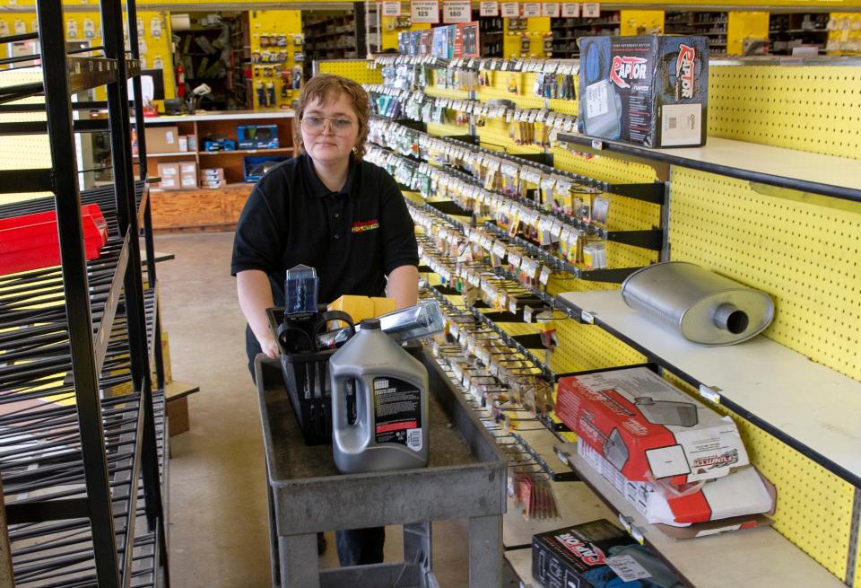 Employee Lake Bupp moves inventory at Knecht's on West 11th in Eugene as the company prepares to close all their stores.