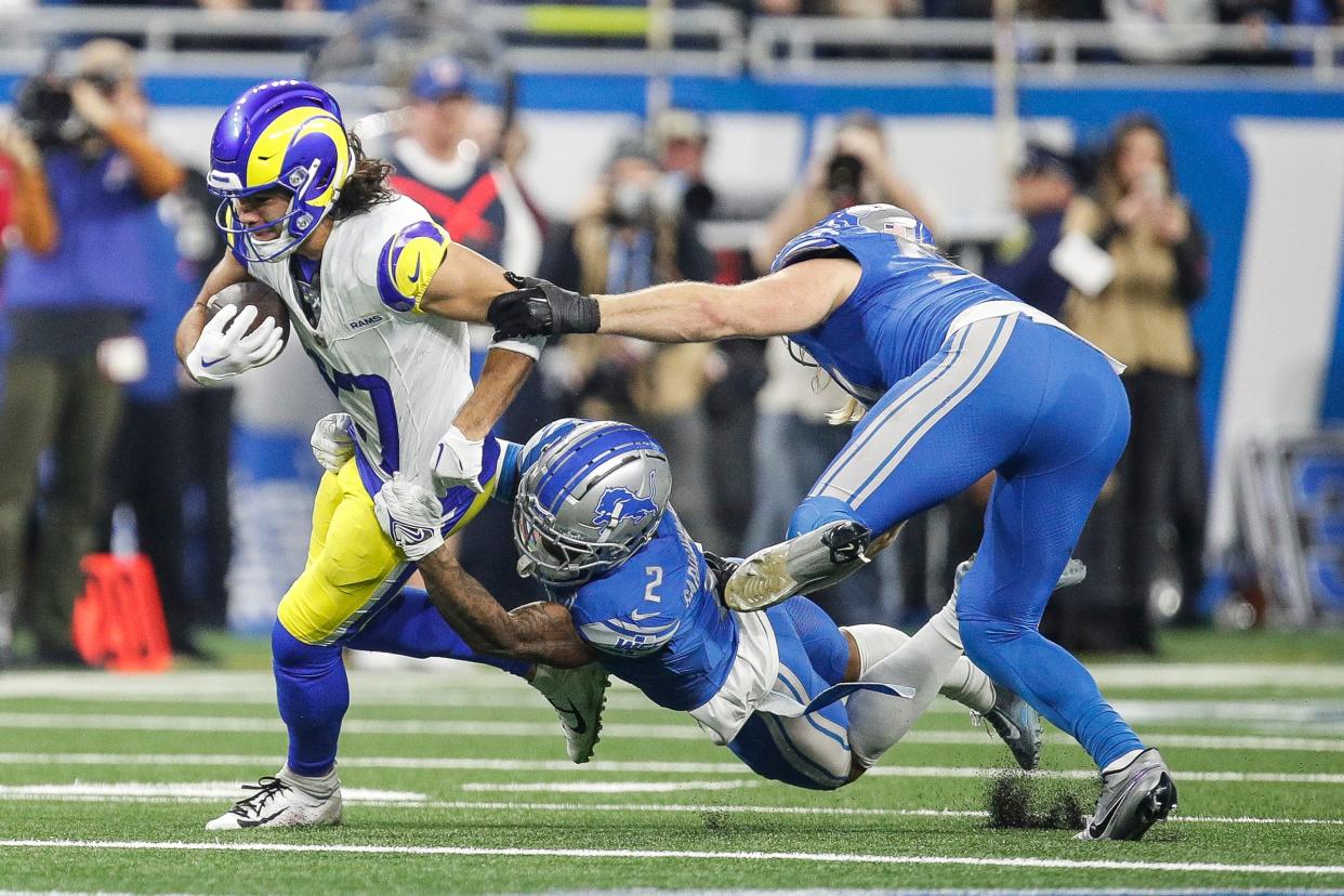 Los Angeles Rams wide receiver Puka Nacua runs against Detroit Lions safety C.J. Gardner-Johnson and linebacker Alex Anzalone during the first half of the NFC wild-card game at Ford Field in Detroit on Sunday, Jan. 14, 2024.