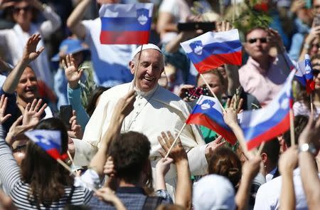 Pope Francis smiles at the end of the Palm Sunday Mass in Saint Peter's Square at the Vatican April 9, 2017. REUTERS/Tony Gentile