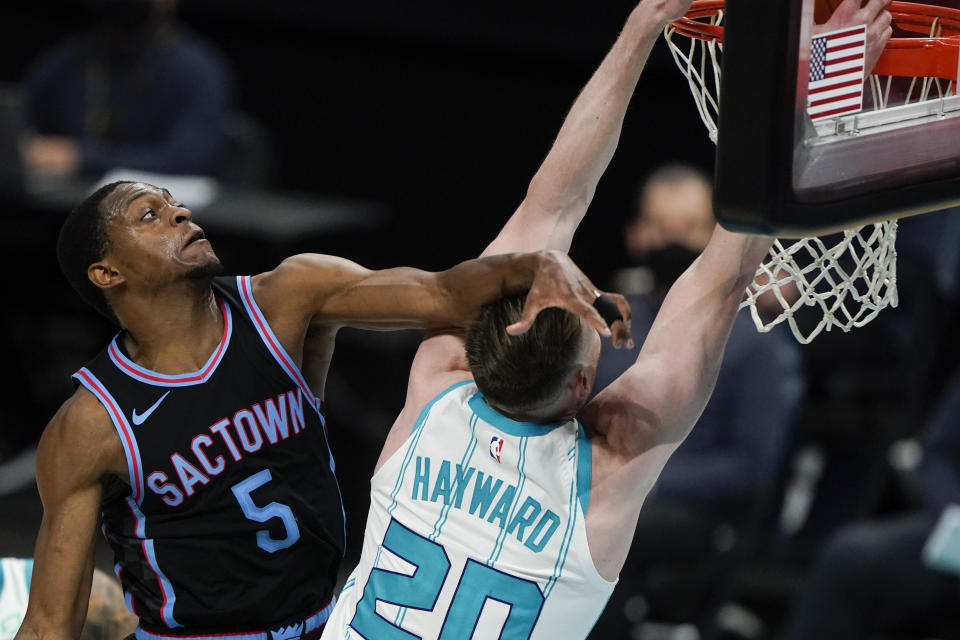 Charlotte Hornets forward Gordon Hayward is fouled by Sacramento Kings guard De'Aaron Fox during the second half of an NBA basketball game on Monday, March 15, 2021, in Charlotte, N.C. (AP Photo/Chris Carlson)
