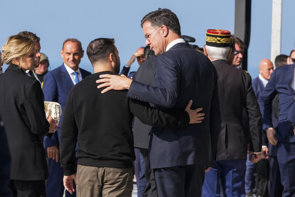 FILE - Ukrainian President Volodymyr Zelenskyy, left, talks to Netherland's Prime Minister Mark Rutte at the end of an international ceremony to mark the 80th anniversary of D-Day at Omaha Beach in Saint-Laurent-sur-Mer, Normandy, France, Thursday, June 6, 2024. NATO on Wednesday, June 26, 2024 appointed Mark Rutte as its next secretary-general, putting the outgoing Dutch prime minister in charge of the world's biggest security organization at a critical time for European security as war rages in Ukraine. (AP Photo/Virginia Mayo, File)