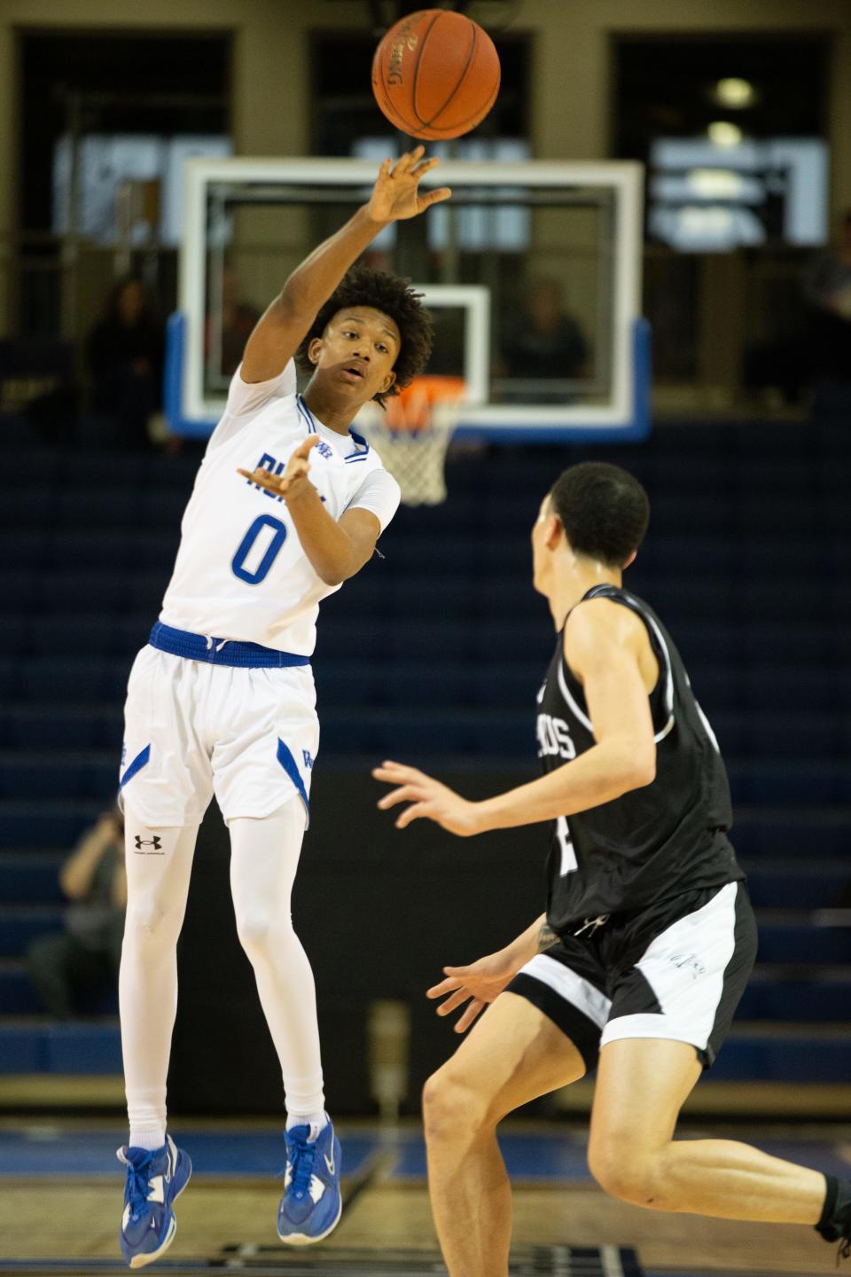 Washburn Rural sophomore Amare Jones (0) passes the ball over Campus during the first half of Tuesday's first round in the KSHSAA 6A Sub-State tournament.