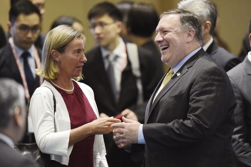 U.S. Secretary of State Mike Pompeo , right, speaks to European Union's Foreign Policy Chief Federica Mogherini ahead of the at the 25th ASEAN Regional Forum Retreat in Singapore, Saturday, Aug. 4, 2018. (AP Photo/Joseph Nair)