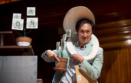 Wearing a toilet seat on his head, David Hu, Associate Professor of Mechanical Engineering and Biology at Georgia Institute of Technology, walks away with his team's Ig Nobel Prize in Physics for testing the biological principle that nearly all mammals empty their bladders in about 21 seconds (plus or minus 13 seconds) at the 25th First Annual Ig Nobel Prizes awards ceremony at Harvard University in Cambridge, Massachusetts September 17, 2015. REUTERS/Gretchen Ertl