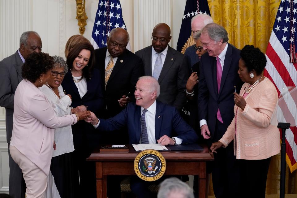 President Joe Biden hands a pen to Rep. Barbara Lee, D-Calif, after signing the Juneteenth National Independence Day Act, in the East Room of the White House, Thursday, June 17, 2021, in Washington.
