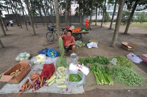 A vendor arranges vegetables in Beijing, on Monday. China's inflation rate slowed to 2.2% in June, official data showed on Monday, giving the government further room to move as it seeks to reignite growth in the world's second biggest economy