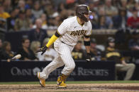 San Diego Padres' Victor Caratini runs to first base after hitting an RBI-single against the Atlanta Braves in the sixth inning of a baseball game Saturday, Sept. 25, 2021, in San Diego. (AP Photo/Derrick Tuskan)