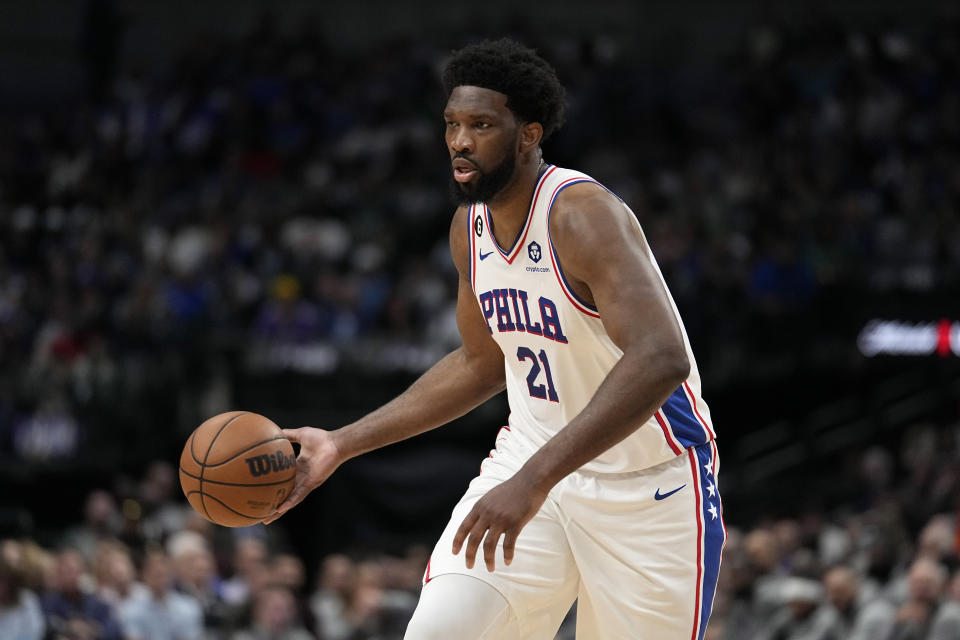 Philadelphia 76ers center Joel Embiid (21) makes a pass as he works against the Dallas Mavericks in the first half of an NBA basketball game, Thursday, March 2, 2023, in Dallas. (AP Photo/Tony Gutierrez)