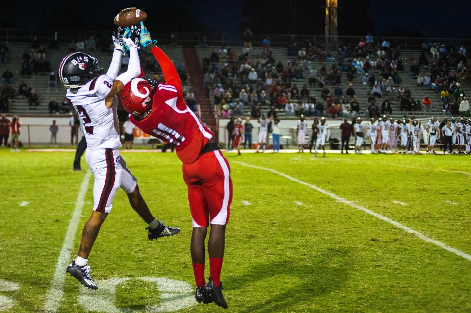 Manual High School wide receiver Jeremiah Blakey, right, goes up to catch a pass while being guarded by Ballard's Jaden Minkins during a football game Friday, Sept. 23, 2022, in Louisville, Ky. The Crimsons defeated the Bruins 21-0.