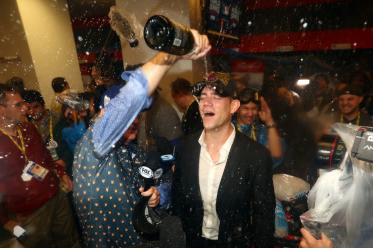 Theo Epstein gets showered in champagne by Bill Murray. (Getty Images)