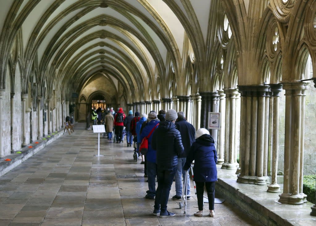 People queue outside Salisbury Cathedral, Wiltshire, to receive an injection of the Pfizer coronavirus vaccine (Steve Parsons/PA) (PA Archive)