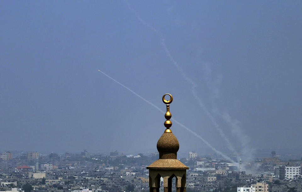 FILE - In this July 14, 2018 file photo, smoke trails are seen as rockets are launched from the Gaza Strip towards Israel, in Gaza City. Hamas officials say Egypt is trying to broker a broad new cease-fire deal between Gaza’s ruling group and Israel to pave the way for Gaza's reconstruction and an eventual prisoner swap. Repeated cease-fire deals over the years collapsed, but there were signs Thursday, Aug. 2, 2018, of possible momentum toward a new agreement, after weeks of escalation between Israel and Hamas. (AP Photo/Sami Shehada, File)