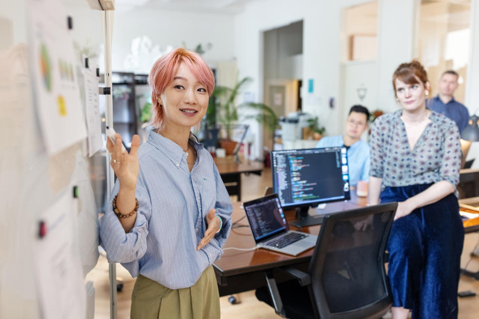 woman presenting data to her colleagues