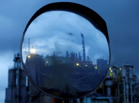 Chimneys of a factory are reflected in a traffic mirror at the Keihin industrial zone in Kawasaki, south of Tokyo, Japan, August 18, 2016. Picture taken on August 18, 2016. REUTERS/Kim Kyung-Hoon