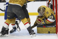 Vegas Golden Knights goaltender Adin Hill (33) makes a save against the Tampa Bay Lightning during the first period of an NHL hockey game Tuesday, March 19, 2024, in Las Vegas. (AP Photo/Ian Maule)