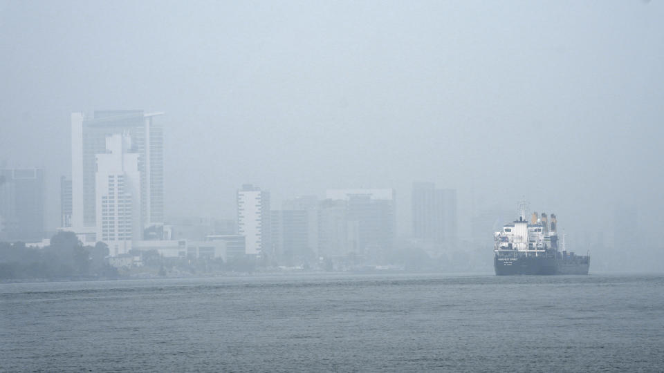 A freighter passes through the Detroit River as smoke fills the sky reducing visibility to Windsor, Ontario Wednesday, June 28, 2023, as seen from Detroit. The Detroit area has some of the worst air quality in the United States as smoke from Canada's wildires spreads southward. (AP Photo/Paul Sancya)