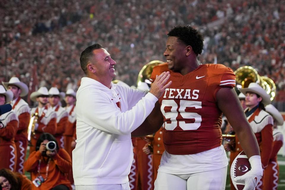 Texas coach Steve Sarkisian congratulates defensive tackle Alfred Collins on senior night in November at Royal-Memorial Stadium. Sarkisian and his staff hope Collins returns for a fifth season, which would bolster a tackle rotation that thinned Thursday with the departure of Trill Carter to the transfer portal.