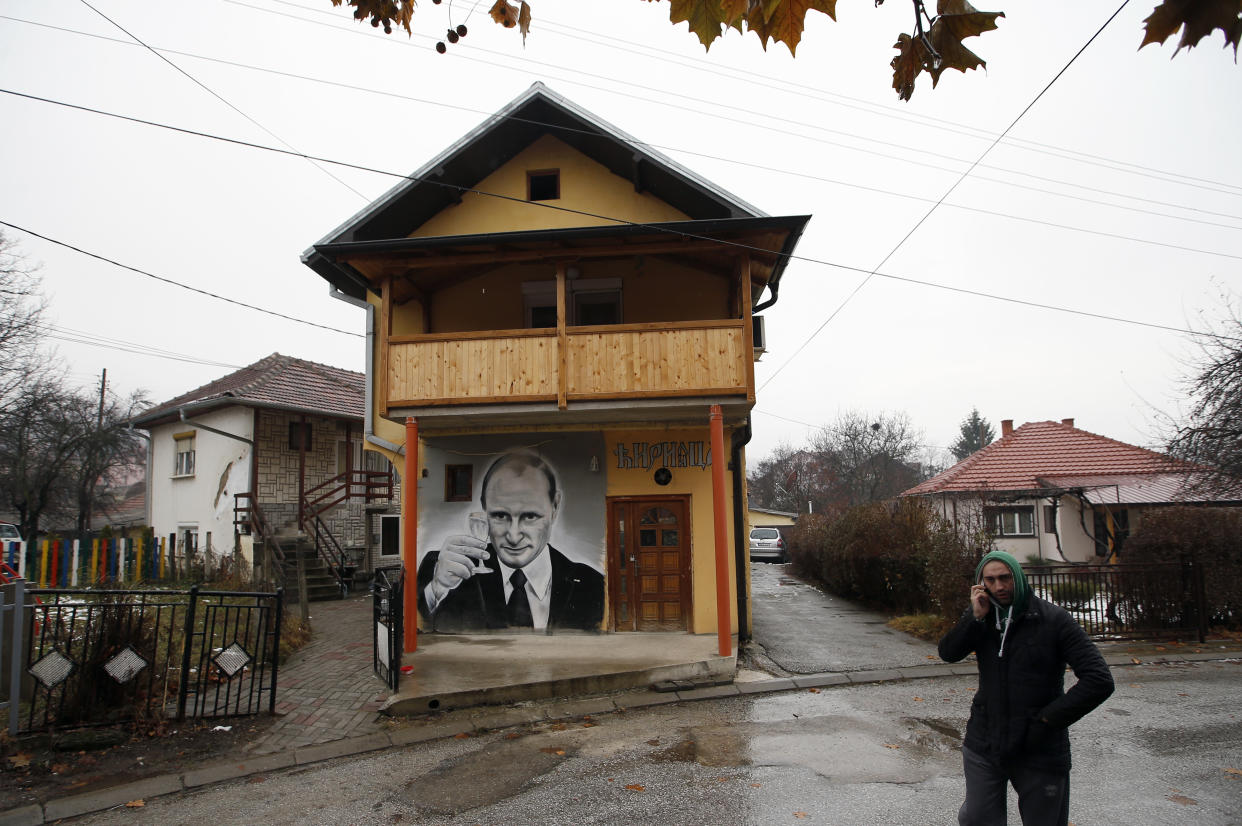 A man walks past a mural depicting Vladimir Putin, in Zvecan, Kosovo, Dec. 15, 2018. For some European countries watching Russia's bloody invasion of Ukraine, there are fears that they could be next. (AP Photo/Darko Vojinovic, File)