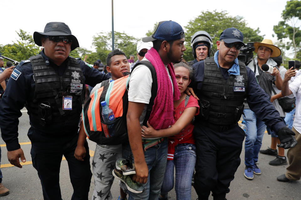 Migrants are detained by Mexican immigration authorities during a raid on a migrant caravan that had earlier crossed the Mexico - Guatemala border, near Metapa, Chiapas state, Mexico, Wednesday, June 5, 2019. U.S. President Donald Trump has pledged to impose 5% tariffs on Mexican products unless Mexico country prevents Central American migrants from traveling through its territory.(AP Photo/Marco Ugarte)