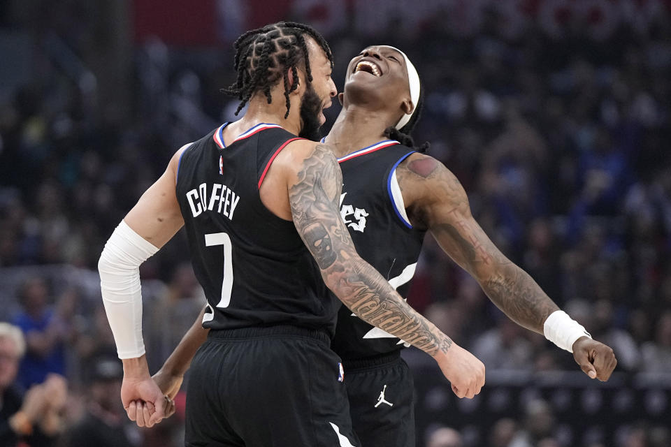 Los Angeles Clippers guard Amir Coffey, left, and guard Terance Mann celebrate after Coffey dunked during the first half of an NBA basketball game against the Toronto Raptors Wednesday, Jan. 10, 2024, in Los Angeles. (AP Photo/Mark J. Terrill)