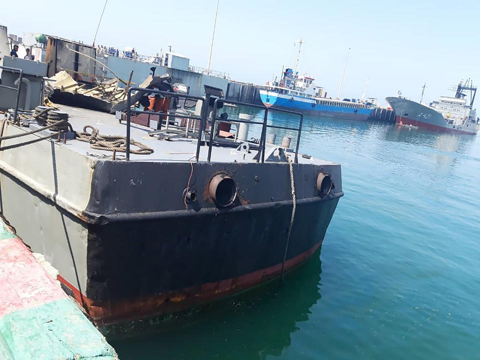 In this photo provided Monday, May 11, 2020, by the Iranian Army, the Konarak support vessel which was struck during a training exercise in the Gulf of Oman, is docked in an unidentified naval base in Iran. An Iranian missile fired during a training exercise in the Gulf of Oman struck a support vessel near its target, killing 19 sailors and wounding 15, Iran's state media reported on Monday, amid heightened tensions between Tehran and the U.S. (Iranian Army via AP)