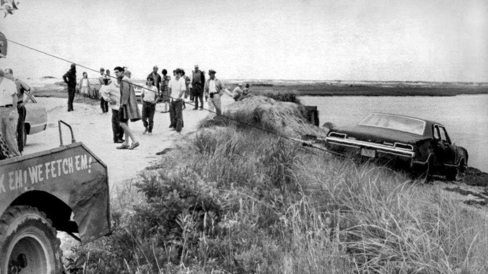 FILE -- In this July 19, 1969 file photograph, U.S. Sen. Edward Kennedy's car is pulled from the water at Edgartown, Mass. Mary Jo Kopechne was drowned after Kennedy drove his car off Dyke Bridge on Chappaquiddick Island. It's been 50 years since the fateful automobile accident that killed a woman and thwarted Kennedy's presidential aspirations. (AP Photo, File)