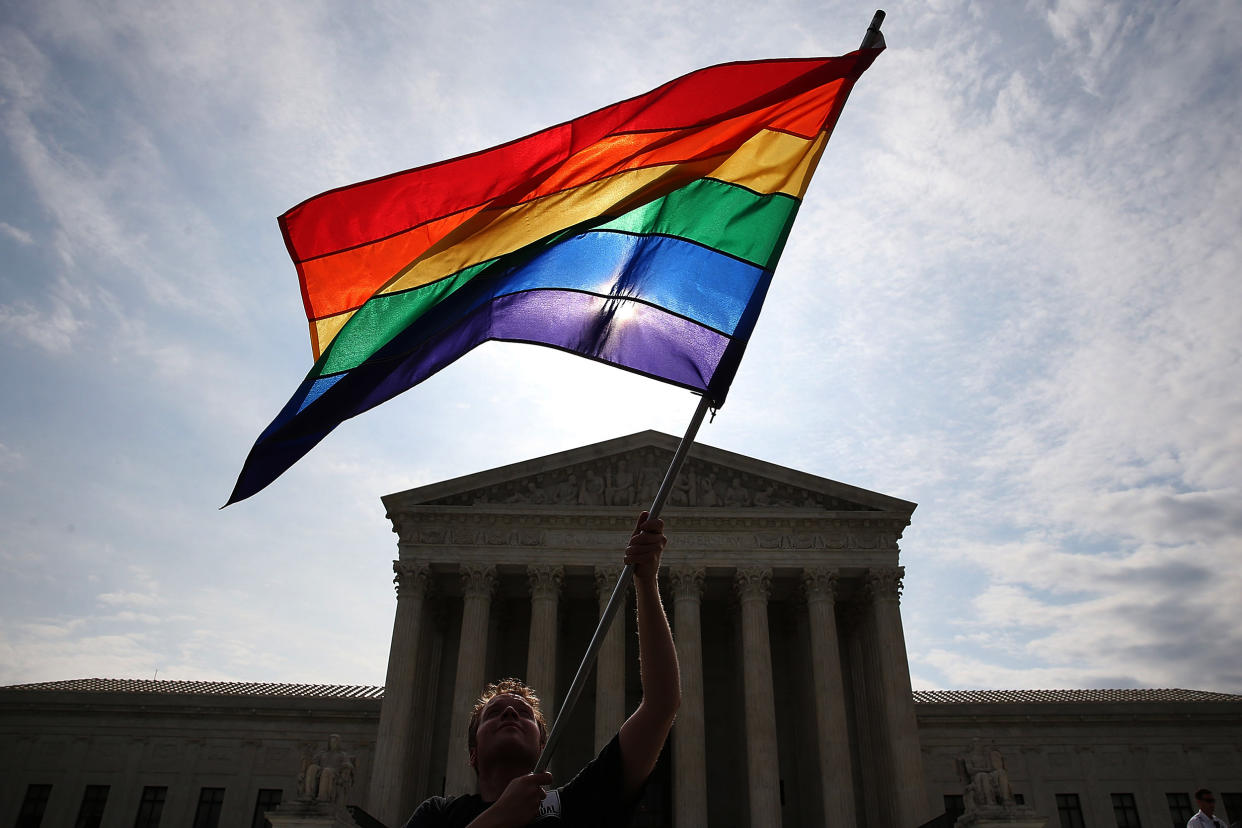 Image:  A supporter of gay marriage waves a flag in front of the Supreme Court Building June 25, 2015. (Mark Wilson / Getty Images file)