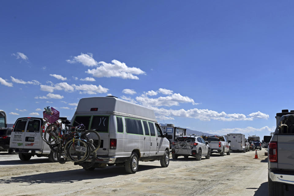 Vehicles line up to leave the Burning Man festival in Black Rock Desert, Nev., Tuesday, Sept. 5, 2023. The traffic jam leaving the festival eased up considerably Tuesday as the exodus from the mud-caked Nevada desert entered a second day following massive rain that left tens of thousands of partygoers stranded there for days. (AP Photo/Andy Barron)