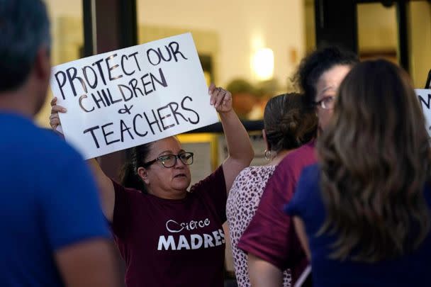 PHOTO: Parents and family of students hold protest signs during a special meeting of the Board of Trustees of Uvalde Consolidated Independent School District where parents addressed the shootings at Robb Elementary School, July 18, 2022, in Uvalde, Texas. (Eric Gay/AP)