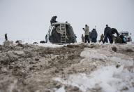 The Soyuz TMA-10M capsule is seen shortly after it landed with former ISS commander Oleg Kotov and flight engineers Sergei Ryazansky and Michael Hopkins from NASA onboard in a remote area southeast of the town of Zhezkazgan in central Kazakhstan, March 11, 2014. An American astronaut and two Russians who carried a Sochi Olympic torch into open space landed safely and on time on Tuesday in Kazakhstan, defying bad weather and ending their 166-day mission aboard the International Space Station (ISS). Inside the capsule were former ISS commander Oleg Kotov and flight engineers Sergei Ryazansky and Michael Hopkins from NASA. The trio launched together into space on September 25. (REUTERS/Bill Ingalls/NASA/Handout via Reuters)