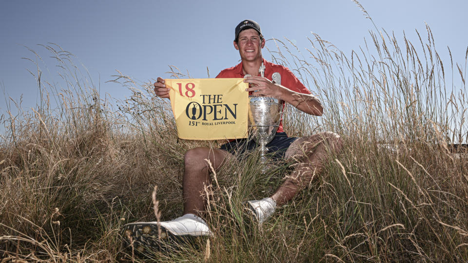 Christo Lamprecht of South Africa poses with the trophy & a 2023 Open Championship flag following his victory during the Final of Match Play on Day Four of The Amateur Championship at Hillside Golf Club