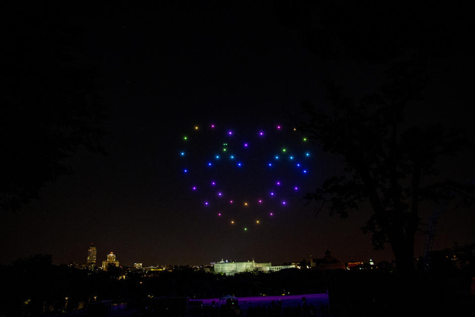 Drones display a heart to pay tribute to honor the victims of COVID-19 and sanitary workers in Madrid, Spain, Friday, June 26, 2020. Spain's cabinet will extend the furlough schemes adopted during the coronavirus lockdown that brought the economy to a standstill until the end of September. (AP Photo/Manu Fernandez)