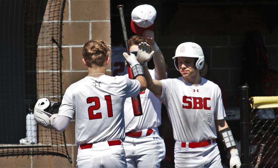 Southern Boone's Austin Evans (21) celebrates with Chase Morris (3) during the Eagles' 8-5 win over Mexico on April 8, 2023, in Ashland, Missouri.