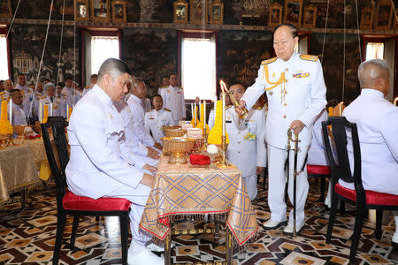 Senior Royal Thai family member Admiral M.C. Pusan Sawasdiwat (R) attends a ritual on behalf of the King Maha Vajiralongkorn to inscribe king's name and title, cast the king's horoscope, and engrave the king's official seal at the Wat Phra Kaew or the Temple of the Emerald Buddha in Bangkok, Thailand April 23, 2019. Thailand Royal Household via REUTERS