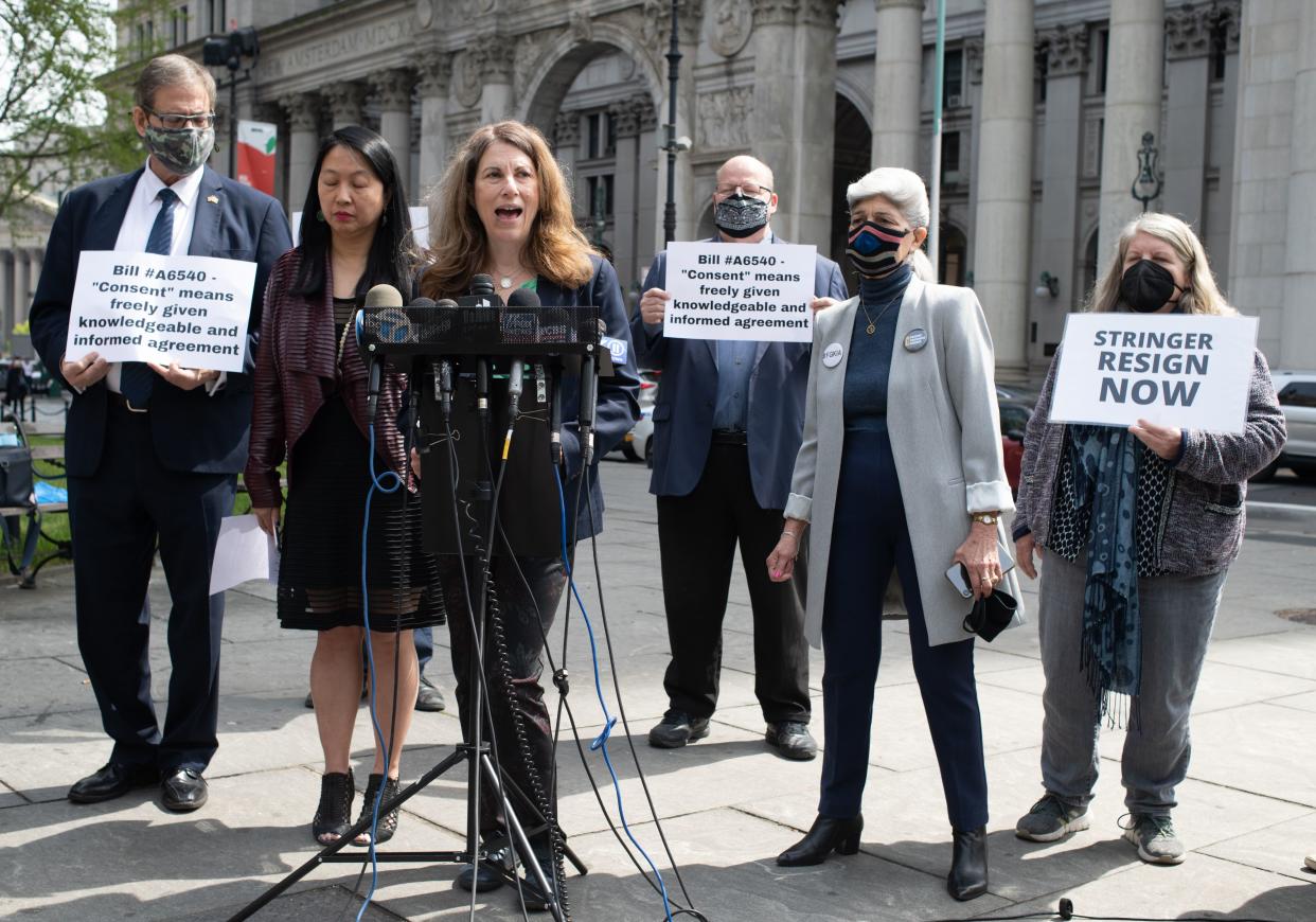 Jean Kim, second from the left, listens during a press conference as her attorney Patricia Pastor, middle, speaks at City Hall Park Wednesday, April 28, in Manhattan, New York. 