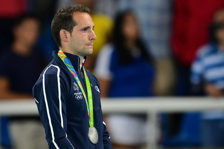 France's Renaud Lavillenie cries on the podium during the medal ceremony for the men's pole vault in Rio de Janeiro on August 16, 2016
