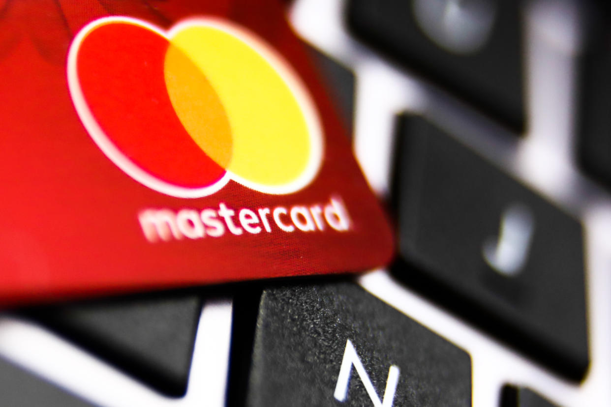 fraud MasterCard logo on a credit card and a laptop keyboard are seen in this illustration photo taken in Krakow, Poland on December 1, 2021. (Photo by Jakub Porzycki/NurPhoto via Getty Images)