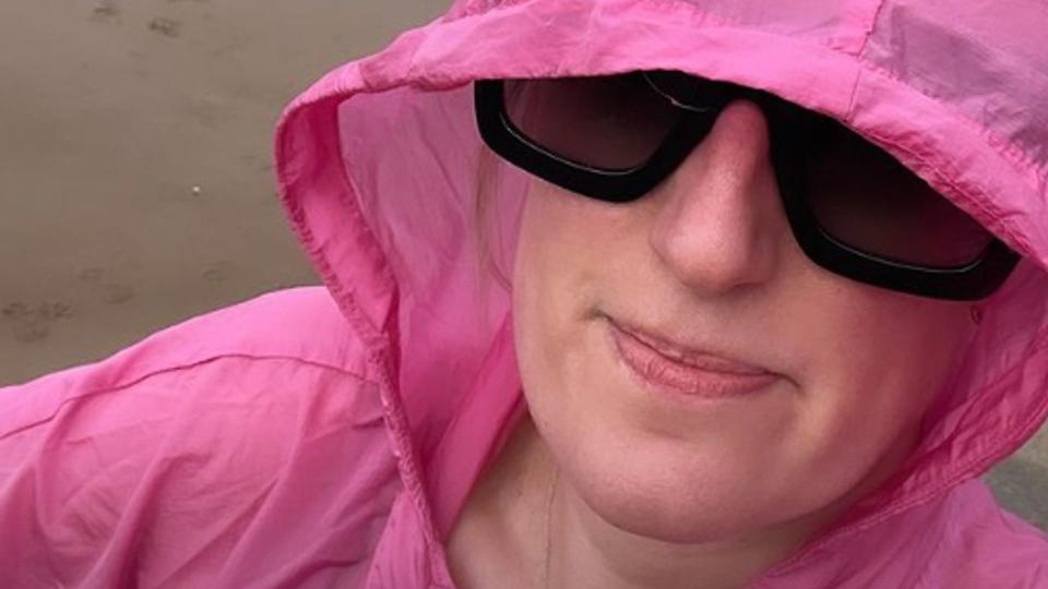 Steph McGovern in a pink parka on the beach