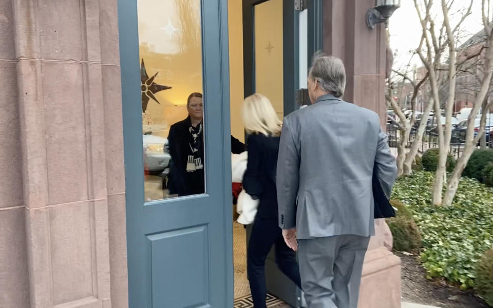 Rep. Andy Biggs enters a building behind another person.