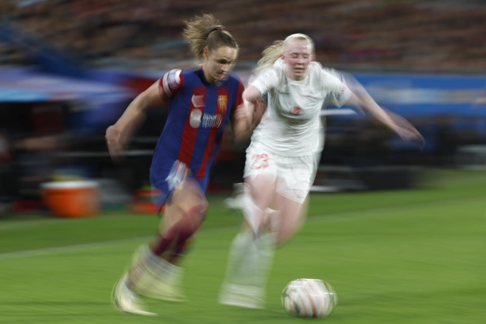 Barcelona's Caroline Graham Hansen, left, challenges for the ball with Brann's Tomine Svendheim during the women's Champions League quarterfinals, second leg, soccer match between FC Barcelona and SK Brann Kvinner at the Estadi Johan Cruyff in Barcelona, Spain, Thursday, March 28, 2024. (AP Photo/Joan Monfort)