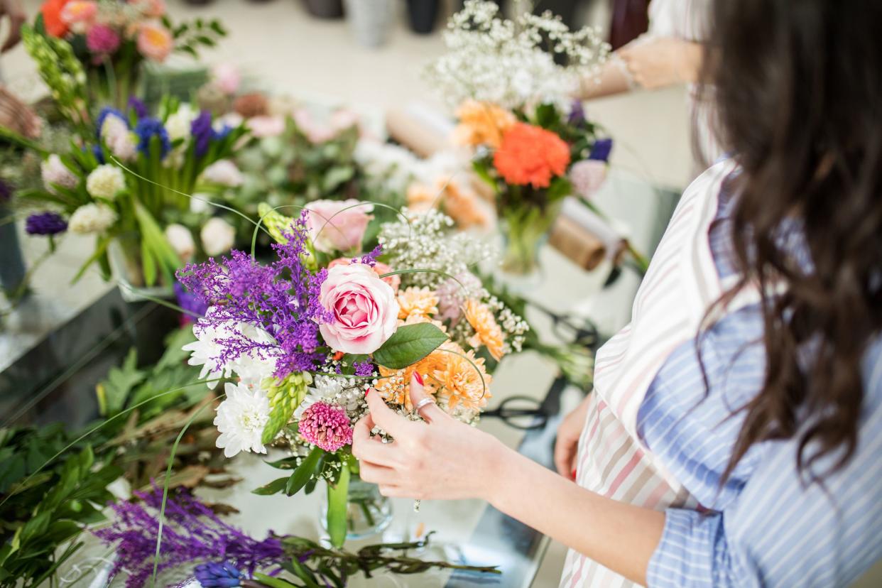 two florists arranging flowers in shop
