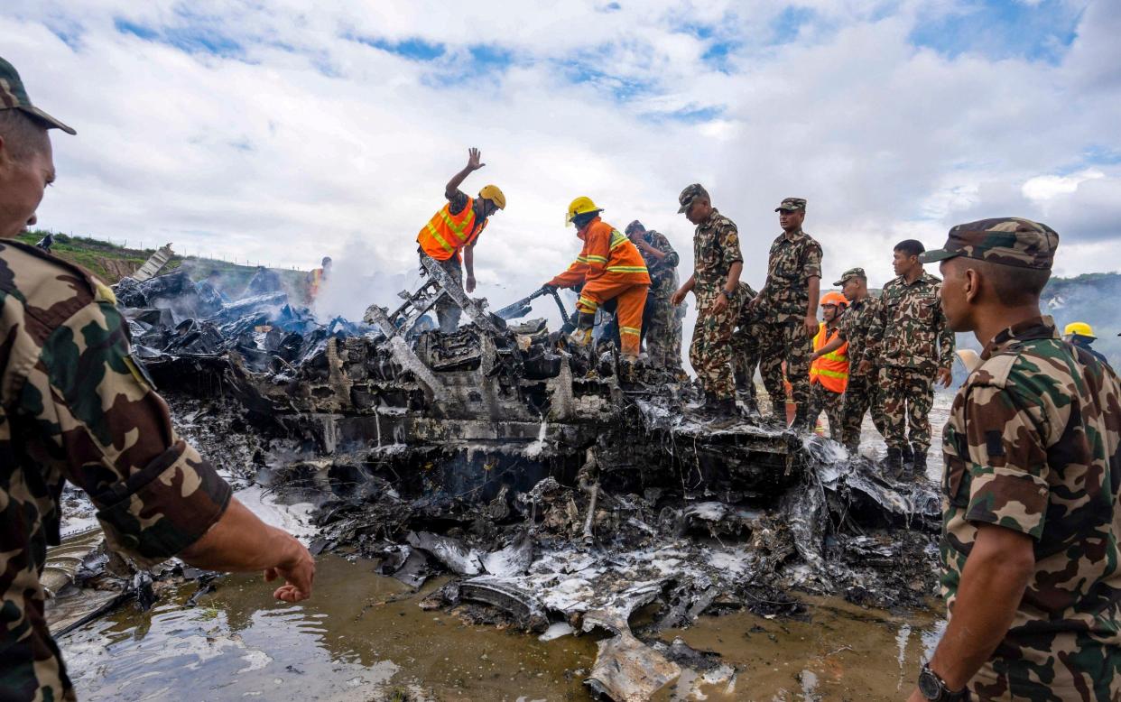 Rescue teams at the crash site where 18 people were killed