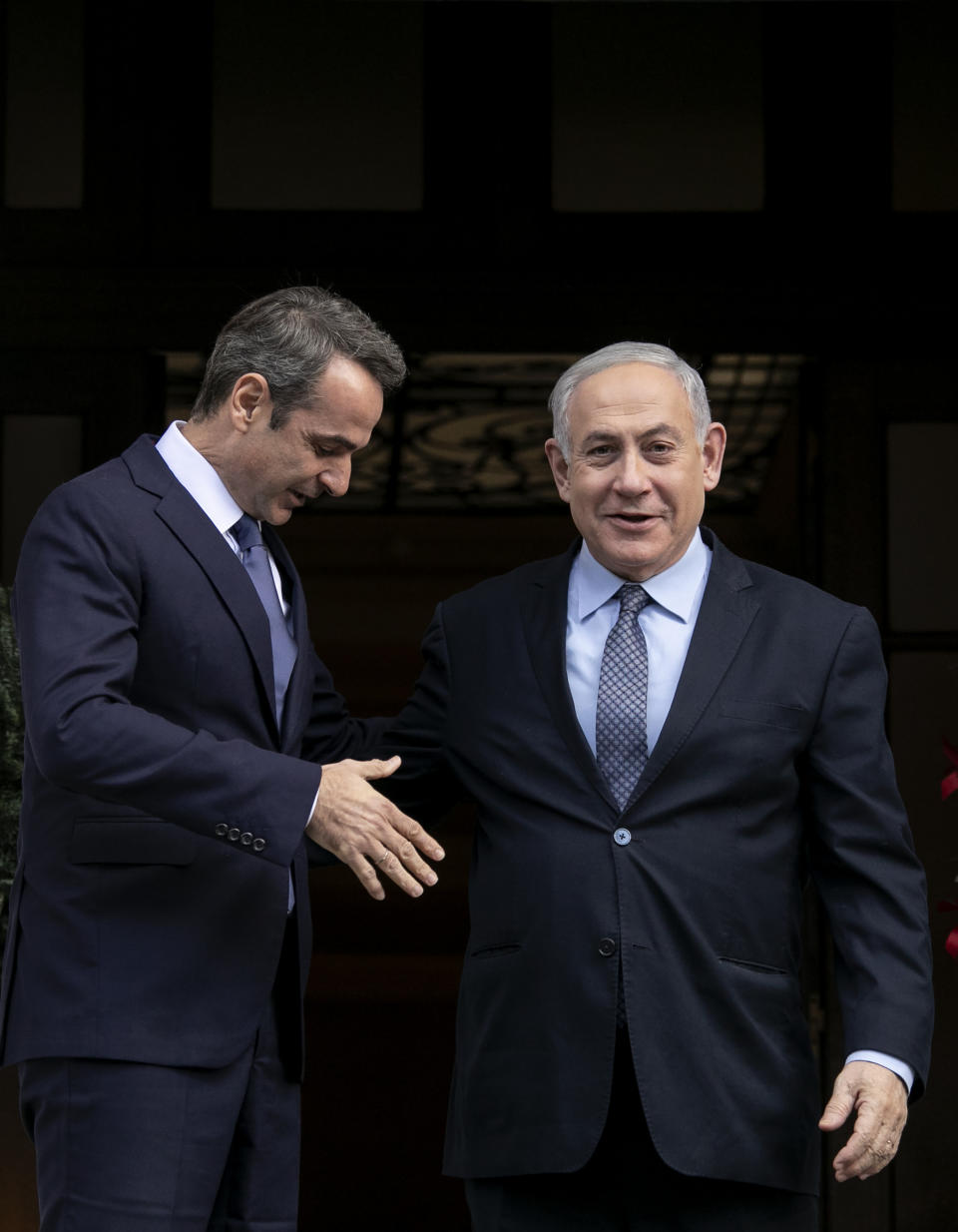 Greece's Prime Minister Kyriakos Mitsotakis, left, welcomes his Israeli counterpart Benjamin Netanyahu in Athens, Thursday, Jan. 2, 2020. The leaders of Greece, Israel and Cyprus will meet in Athens Thursday to sign a deal aiming to build a key undersea pipeline, named EastMed, designed to carry gas from new rich offshore deposits in the southeastern Mediterranean to continental Europe.(AP Photo/Yorgos Karahalis)